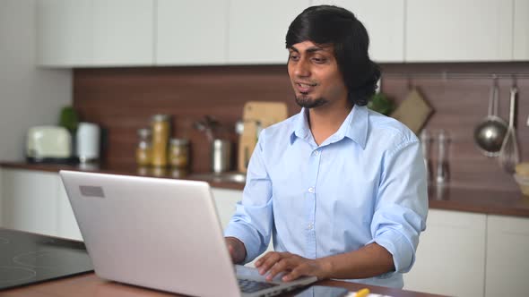 Indian Man Wearing Talks Online Using Laptop Computer for Video Connection