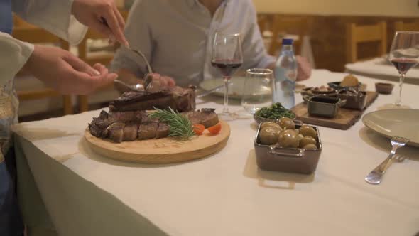 Waiter Serves Customers In Restaurant alt