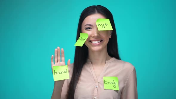 Female Student Learning English, Covered With Body Parts Sticky Notes, Education alt