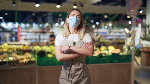 Portrait young woman worker seller in a Vegetable section supermarket  alt