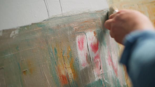 Slow Motion Creative Person at Work a Talented Man Artist Covers the Canvas with Oil Paint Priming alt