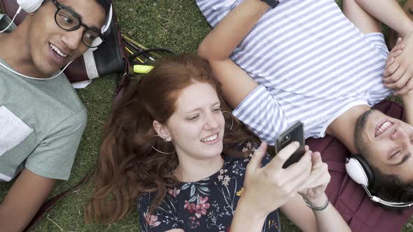 College students using smartphone and listening to music in campus