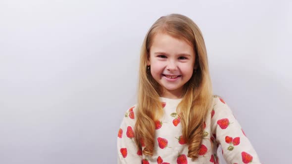 Positive Kid Presenting Product Over White Background alt