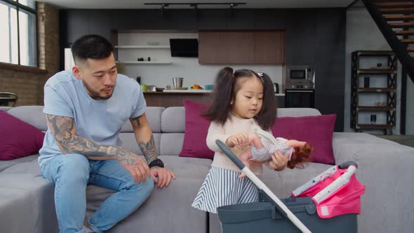 Asian Dad Babysitting Toddler Daughter Playing with Kids Stroller alt