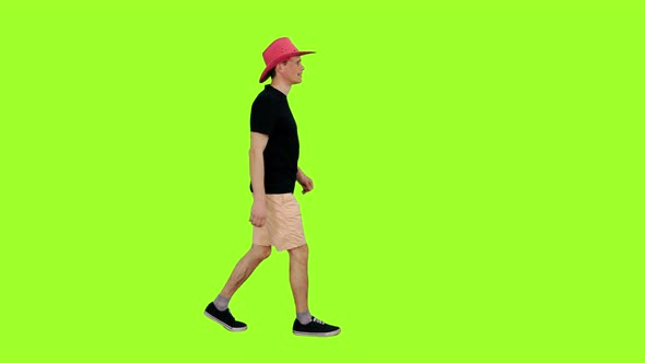 Walking Young Man in Black T-shirt and Pink Cowboy Hat