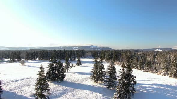 Ariel footage of snow covered landscapes. alt