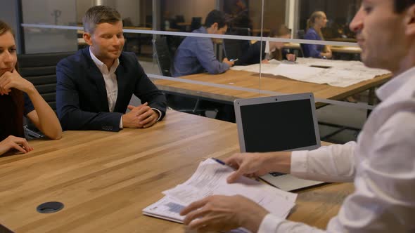 Group of Smiling Businesspeople Meeting in Office Boardroom. alt