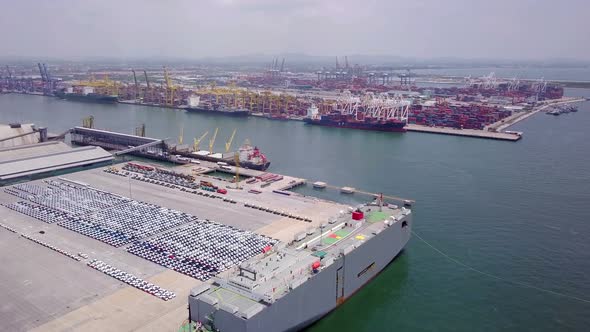 Aerial view of logistics concept of commercial vehicles, cars and pickup trucks waiting to be load o alt