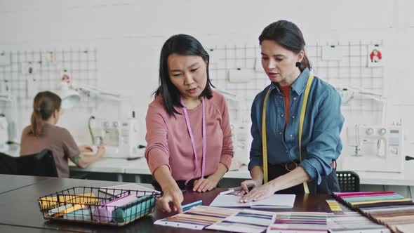 Young Women Designing Garment in Studio alt