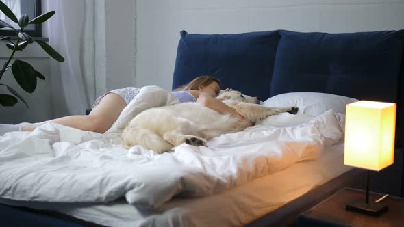 Woman and Her Best Friend Pet Dog Sleeping in Bed alt