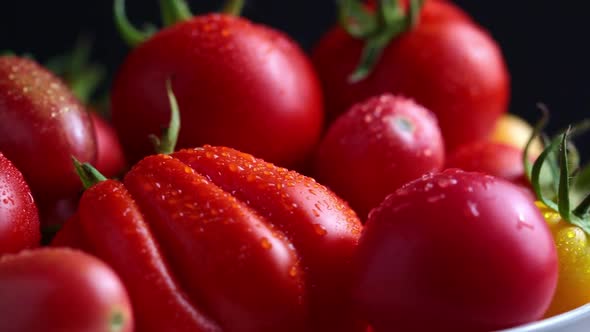 Fresh red tomatoes, rotation on black background alt
