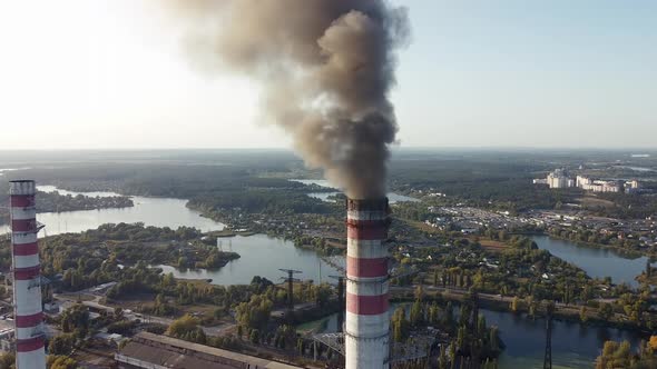 Environmental pollution by industrial plants throwing out harmful smoke from the chimney alt