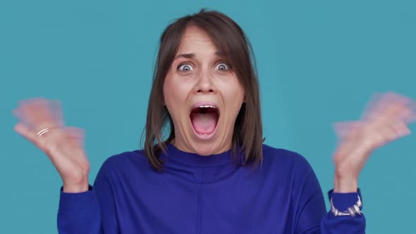 Portrait of Lucky Woman Being Ecstatic Gesturing with Hands Clenching Fists Screaming in Happiness alt