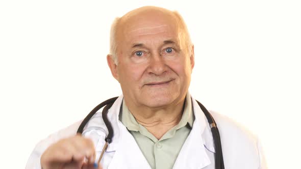 Cheerful Senior Male Doctor Holding a Blue Pill alt