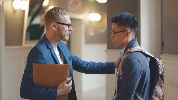 Professor Helping Asian Student with Homework or Thesis in College Corridor alt