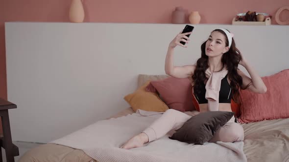 Woman Take Selfie at Home in Cute Feminine Pink Bedroom. Teenage Girl Blogger Make Self Portrait