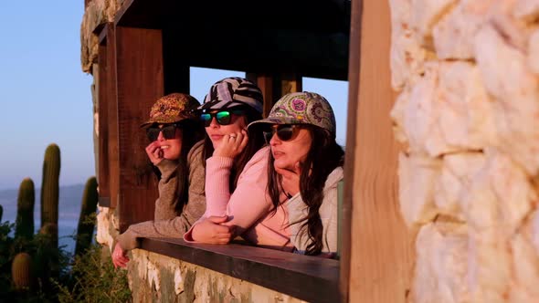 group of cheerful women looking at the sea, while they talk to each other, pichilemu, punta de lobos alt