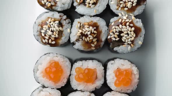 Fresh Sushi Roll Set Rotating. Typical Japanese Food, Dish Consisting of Rice, Avocado, Salmon, Tuna alt