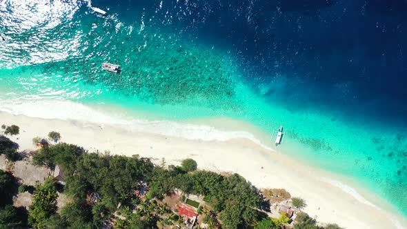 Tropical above tourism shot of a white sandy paradise beach and turquoise sea background  alt