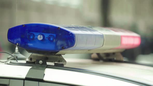 Flashing Flasher on the Roof of a Police Car. Blinker. Close-up. alt