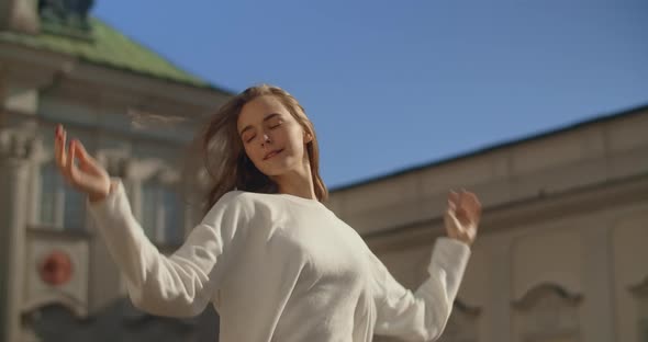 Handheld Camera Shot Casual Dressed Woman are Posing in Slow Motion in Old Town Lifestyle Footage of alt