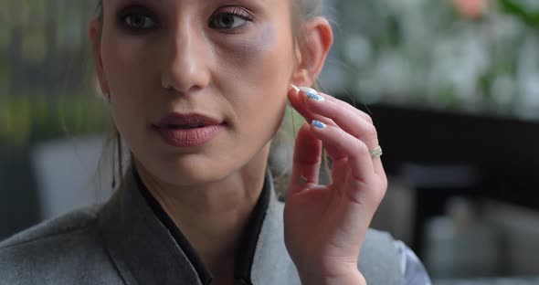 Confused Woman Covers A Bruise With Her Hand. He Suffered From Domestic Violence alt