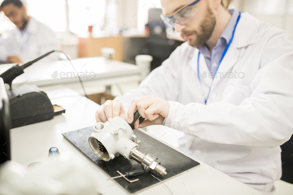 Concentrated technician finding out reason of transducer breakdo