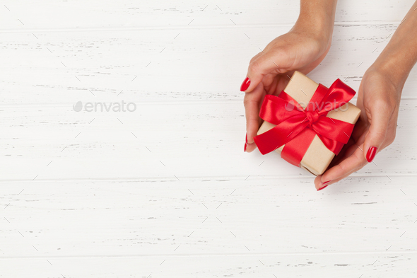 Woman hands holding gift box - Stock Photo - Images