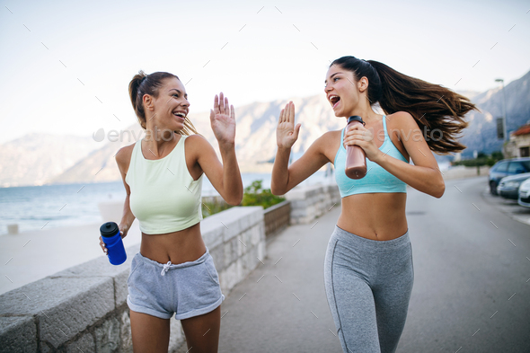 Happy people jogging outdoor. Running, sport, exercising and healthy lifestyle concept - Stock Photo - Images