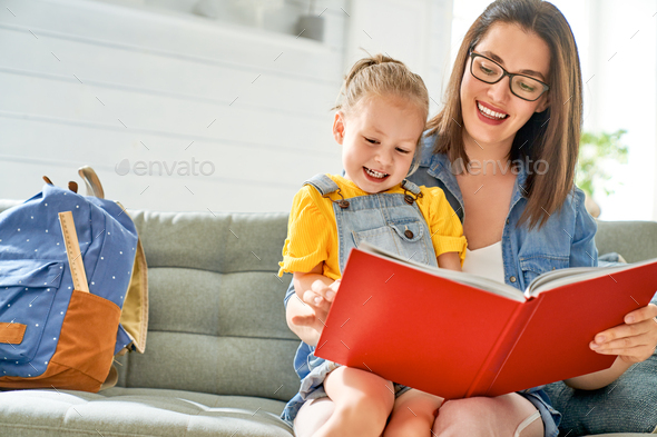 mother and daughter are reading a book. - Stock Photo - Images