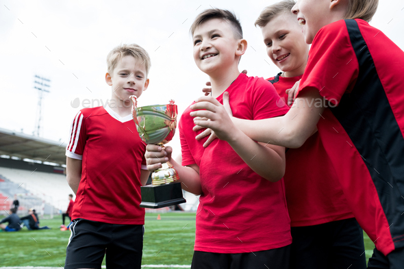Junior Football Team Holding Cup