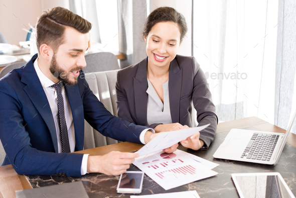 Optimistic forecasting managers discussing papers - Stock Photo - Images