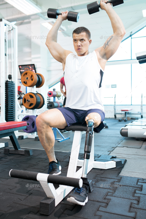 Man is lifting dumbbells - Stock Photo - Images