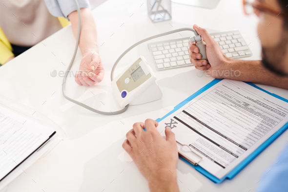 Doctor Measuring Blood Pressure - Stock Photo - Images