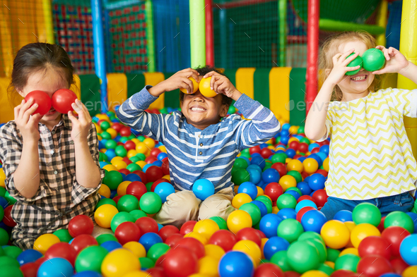 Happy Kids Playing in Ball Pit