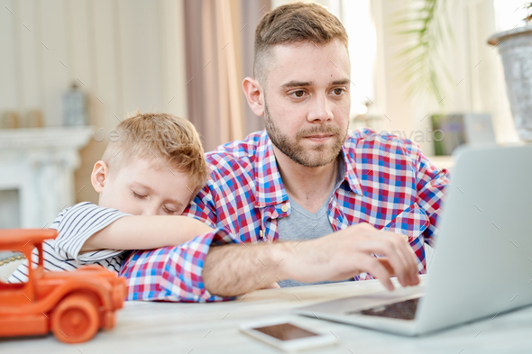 Busy Dad Working at Laptop - Stock Photo - Images
