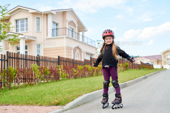 Girl Roller Skating in Street - Stock Photo - Images