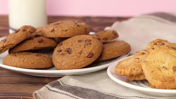 Pile of Chocolate Chip Cookies on White Plate on Wooden Table