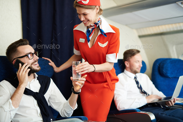Flight Attendant Serving Drinks - Stock Photo - Images