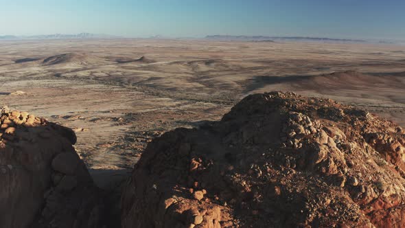 Vast Arid Landscape Revealed Behind Granite Peak. Spitzkoppe In The Namib Desert In Namibia. drone s alt