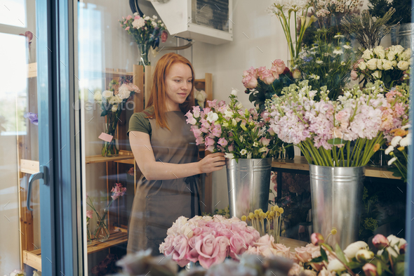 Young flower shop worker checking flowers - Stock Photo - Images