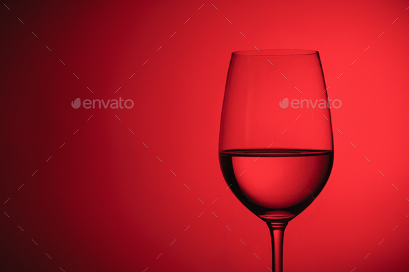 Glass of wine over a red background