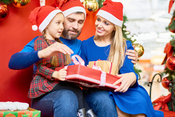 Loving family with Christmas presents in mall - Stock Photo - Images