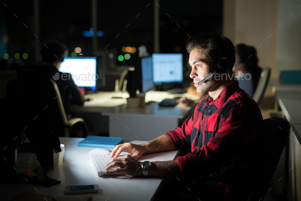 Help Desk Operator Working At Night Stock Photo By Seventyfourimages