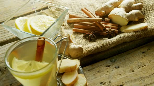 Herbal tea with lemon, cinnamon sticks and ginger 4k alt