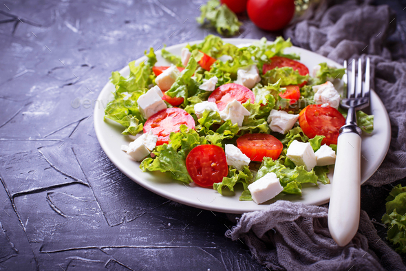 Healthy salad with tomato and feta cheese - Stock Photo - Images