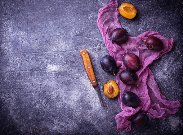 Fresh sweet plums on concrete background - Stock Photo - Images