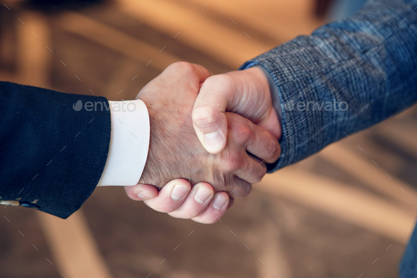 Men shake hands at business meeting - Stock Photo - Images