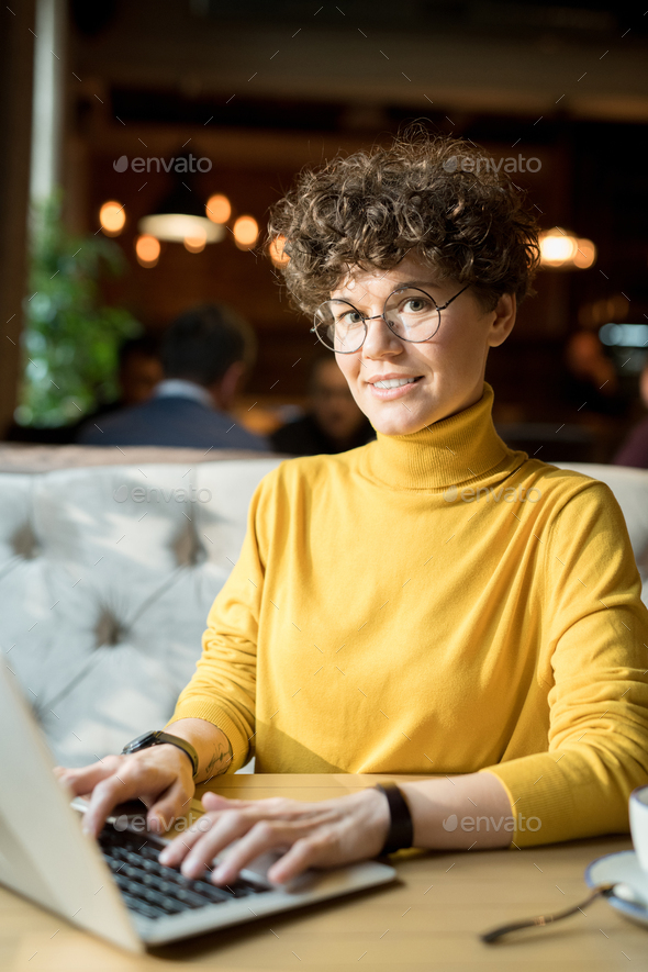 Cheerful hipster woman working with laptop - Stock Photo - Images