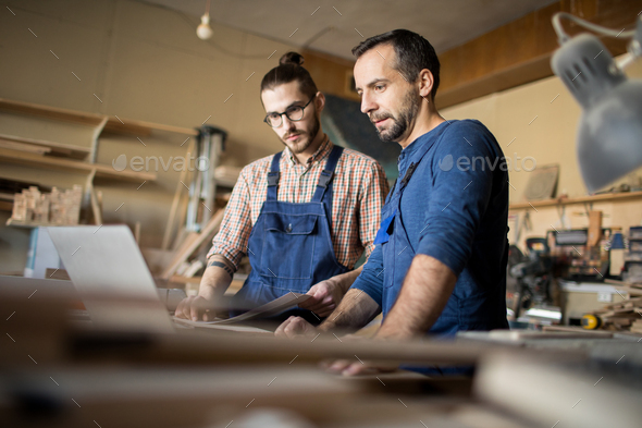 Two Modern Carpenters Working on Project - Stock Photo - Images